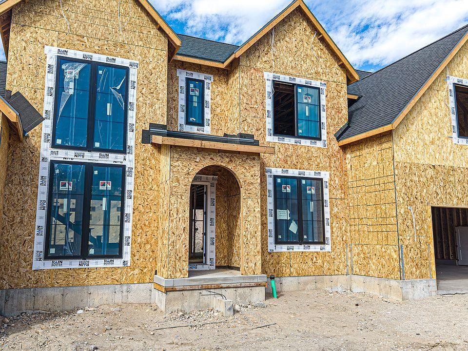 New custom home under construction with sheathing and windows installed
