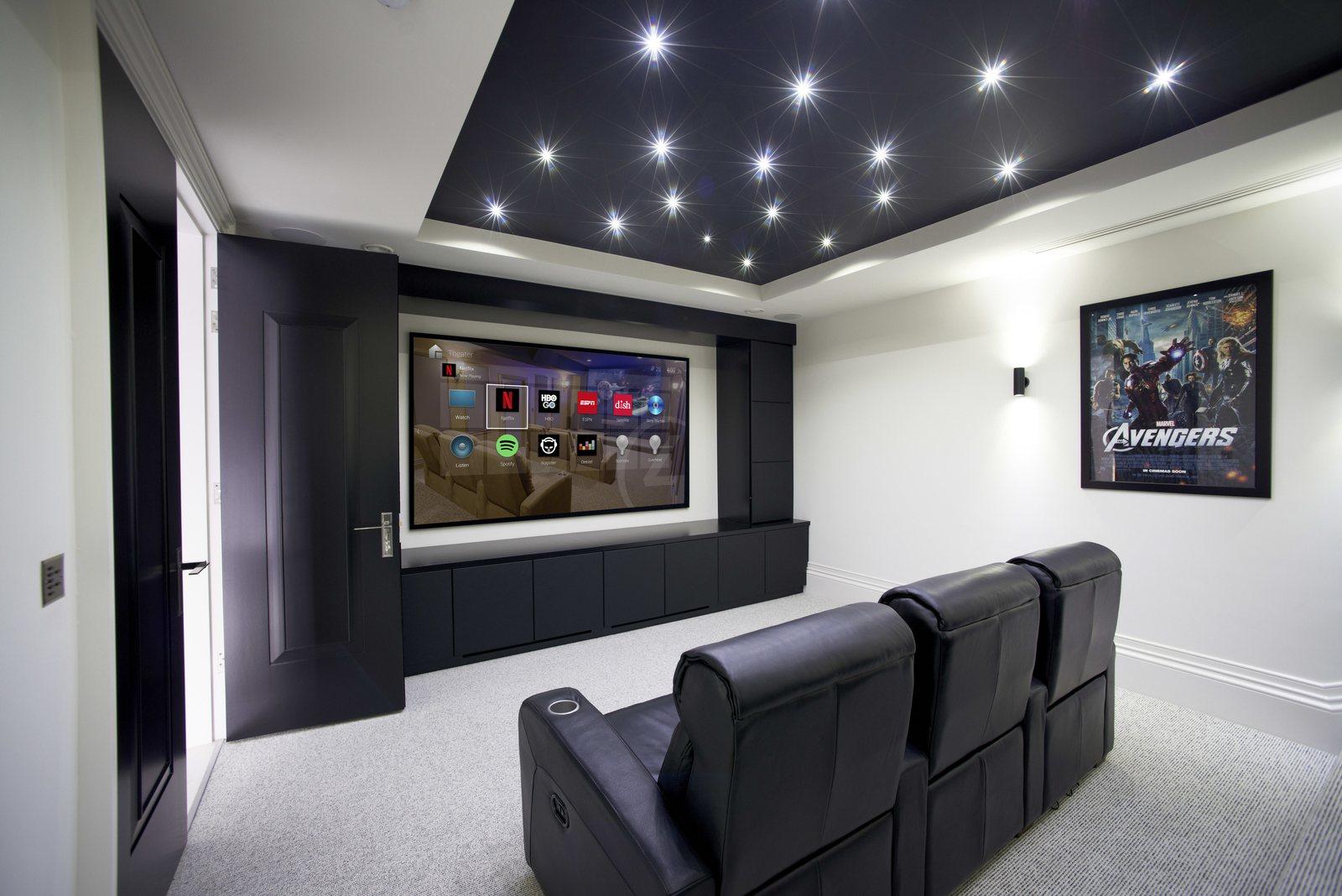 Home theater with a starry ceiling, projection screen and leather recliners